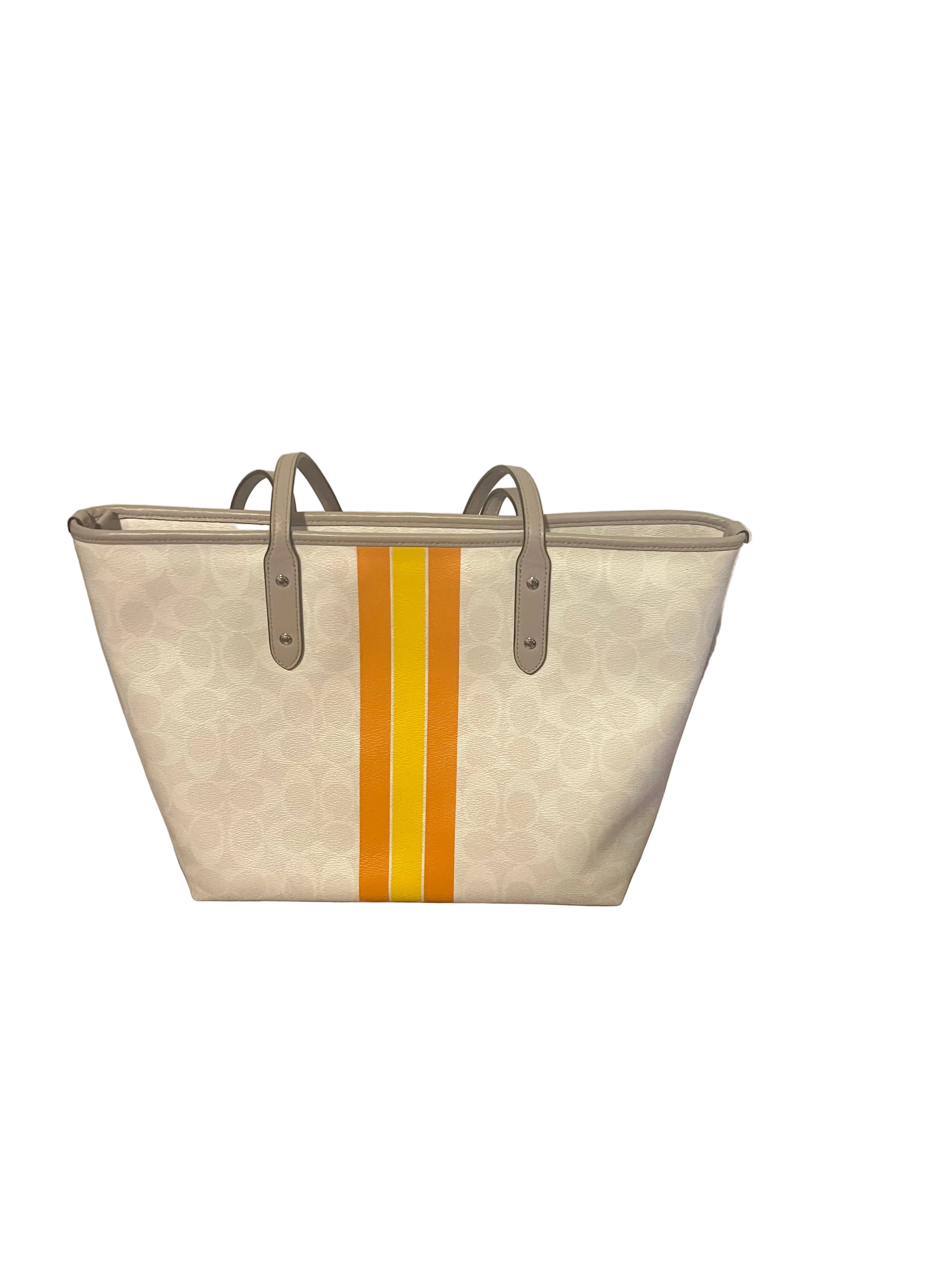 Back of Coach tote bag in its signature monogram canvas, featuring a vertical stripe pattern in yellow and orange down the center, with taupe leather handles.